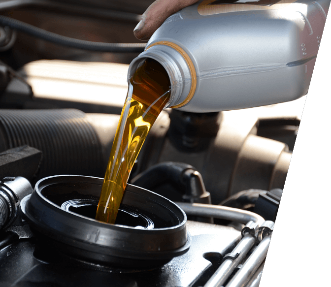 Mechanic pouring liquid in engine